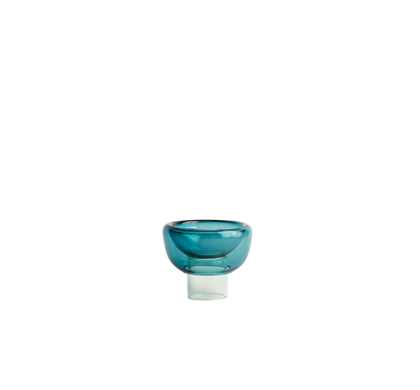 semi-transparent light mint blue cylinder glass base holding a semi-transparent a light cyan moon shape glass forming a bowl on a white background