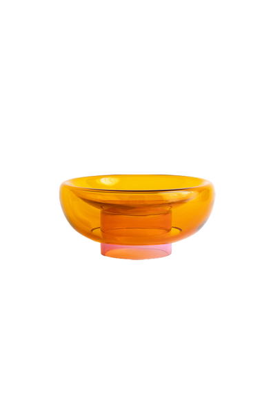semi-transparent orange cylinder glass base holding a semi-transparent deep yellow moon shape glass forming a bowl on a white background