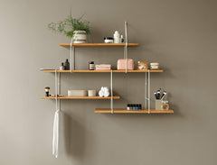 hanging oak shelf with white brackets on a brown background with decoration and plants on it