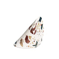 cylinder of terrazzo cut in a triangle shape containing natural earthy colors chips of stone on white background