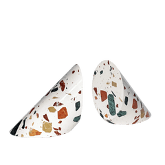 set of two cylinder of terrazzo cut in a triangle shape containing natural earthy colors chips of stone on white background